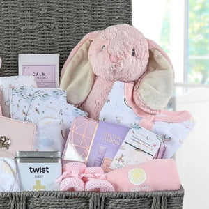 Large baby girl hamper gifts basket with bunny and clothing.