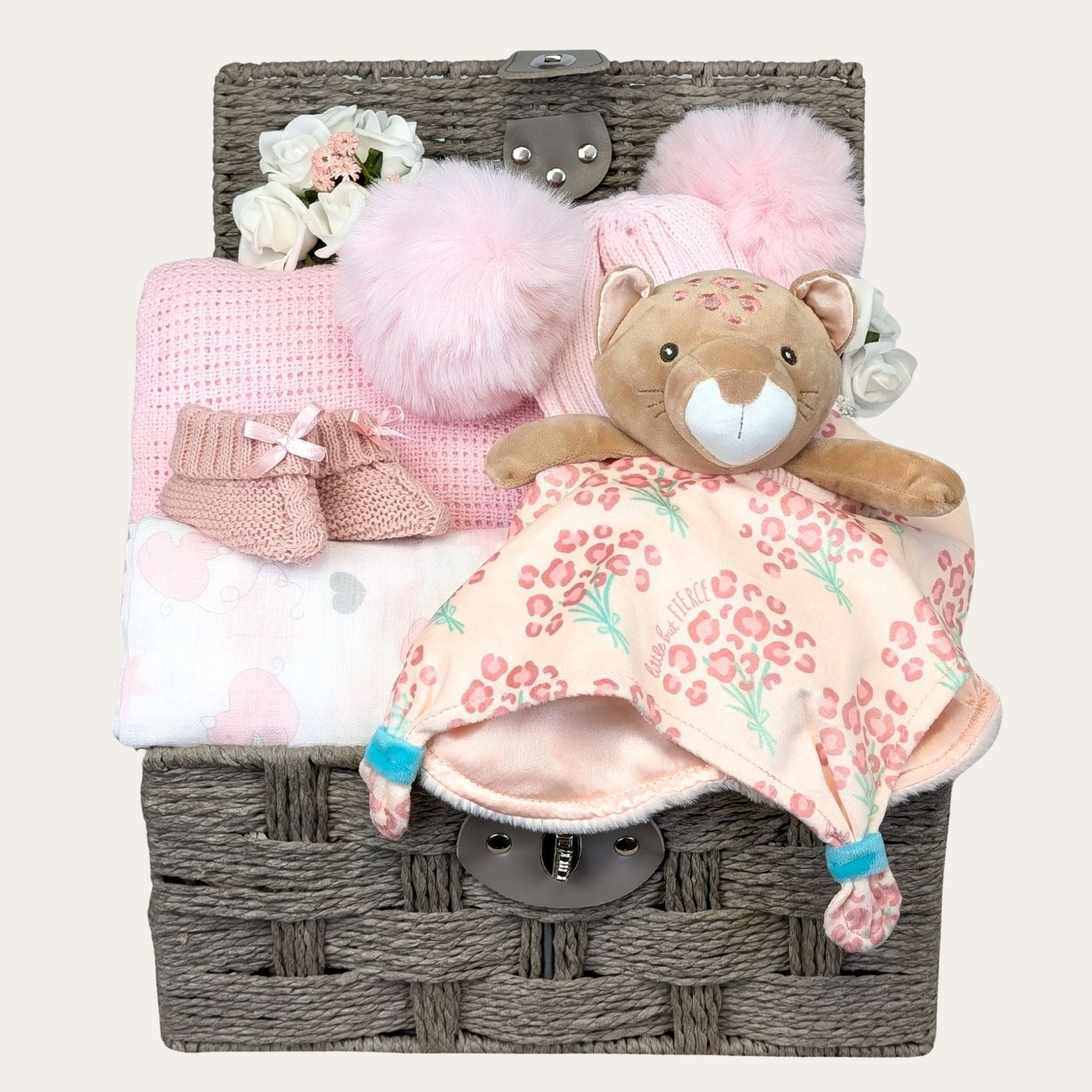 baby hamper basket with leopard satin comforter, baby blanket, baby pompom hat, muslin and baby booties.