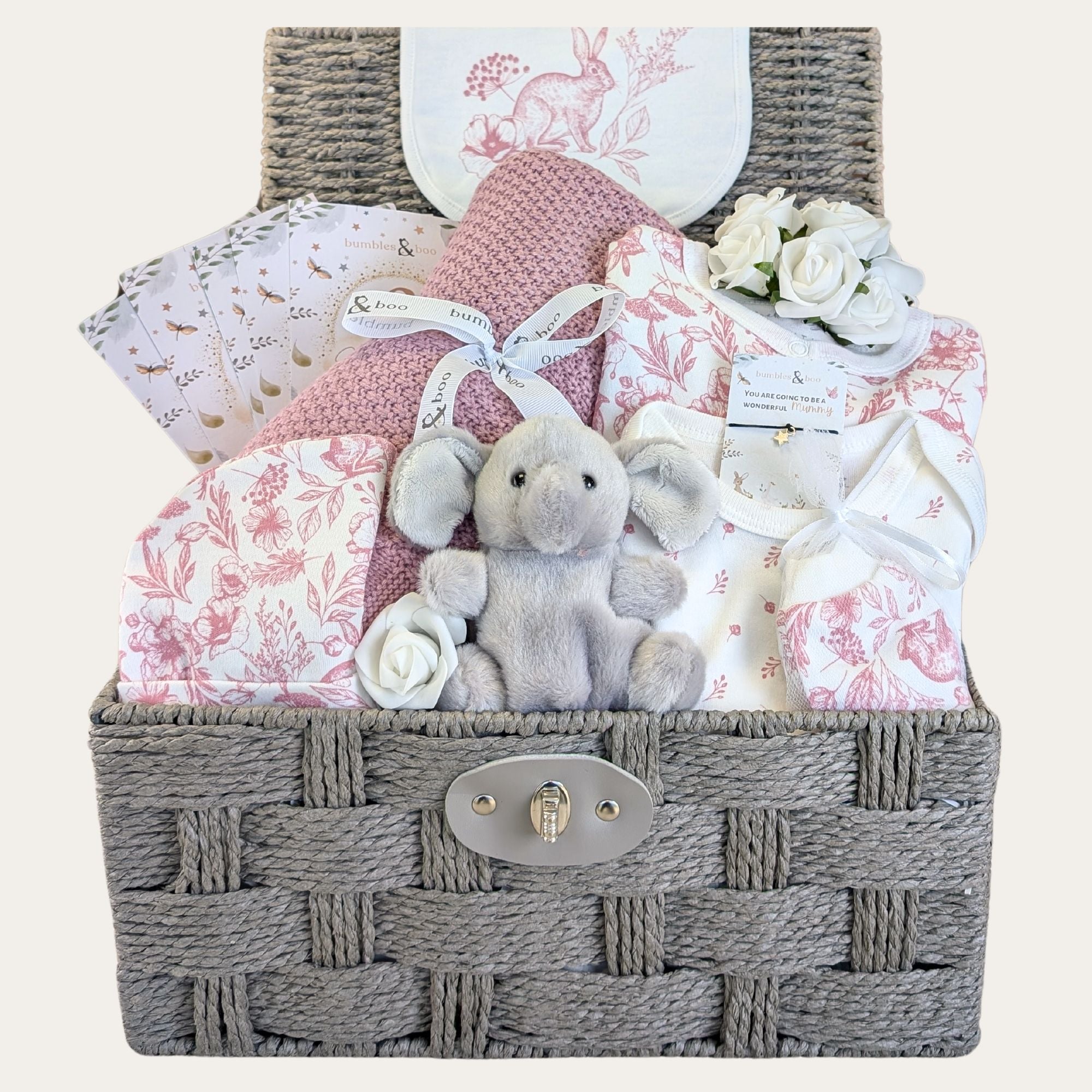 Baby girl hamper packed with gifts. Dusky pink clothing set, baby blanket and elephant soft toy.