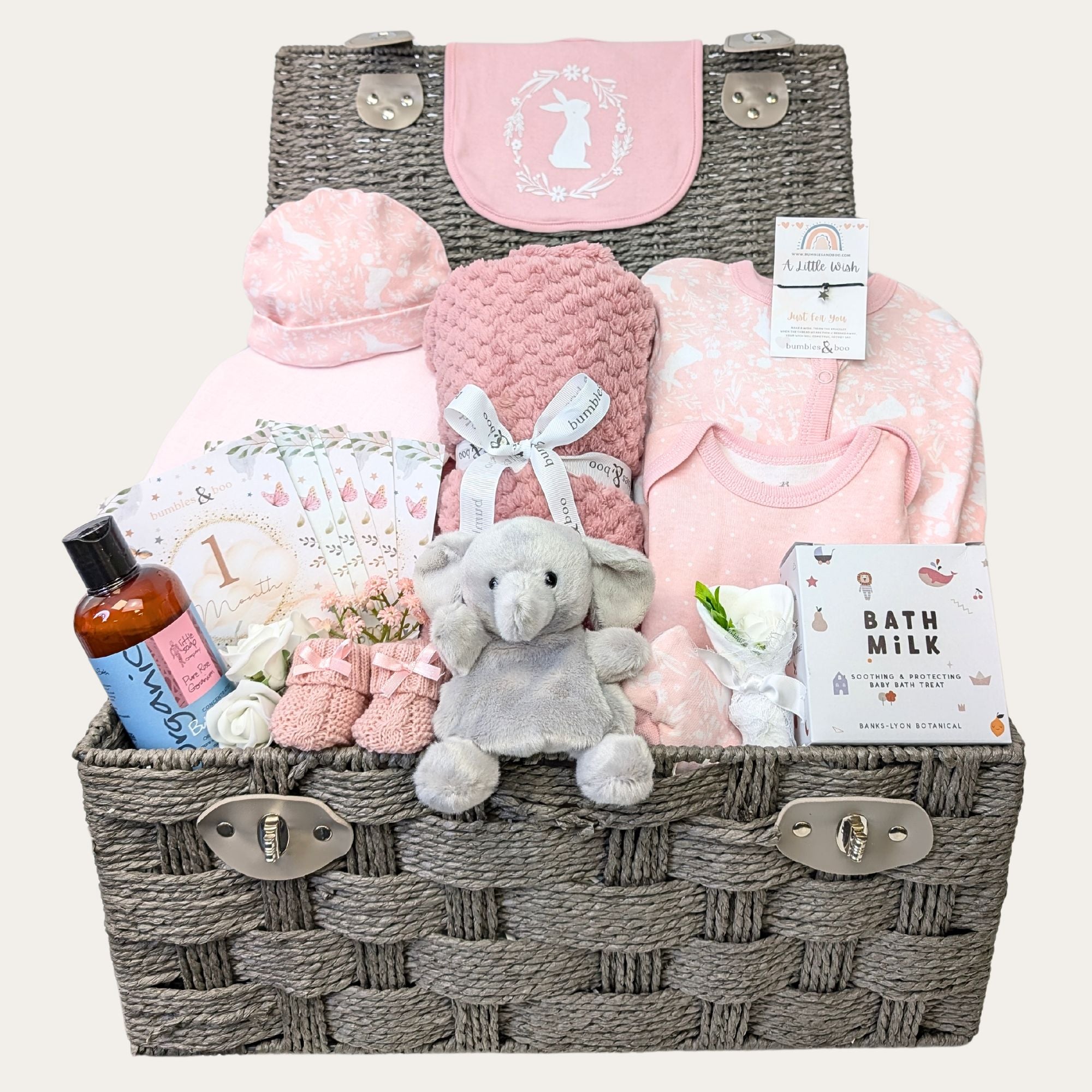 Baby girl hamper packed with gifts. Dusky pink clothing set, baby blanket and elephant soft toy.