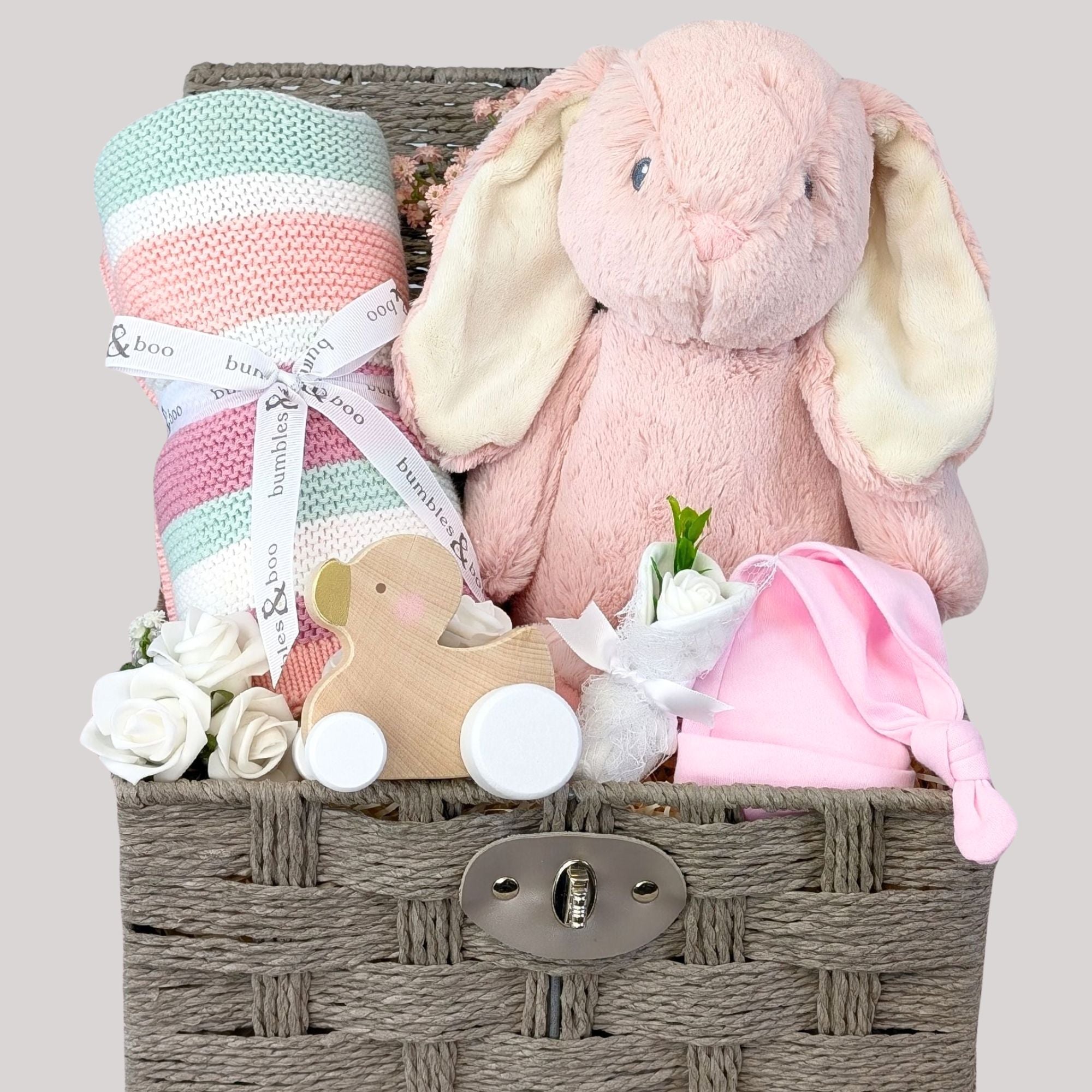 Baby girl gifts hamper basket - gifts include pink bunny, pink stripes blanket and muslins.