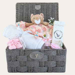 Brown Rope baby girl hamper packed with pink and grey newborn gifts including leopard printed comforter.