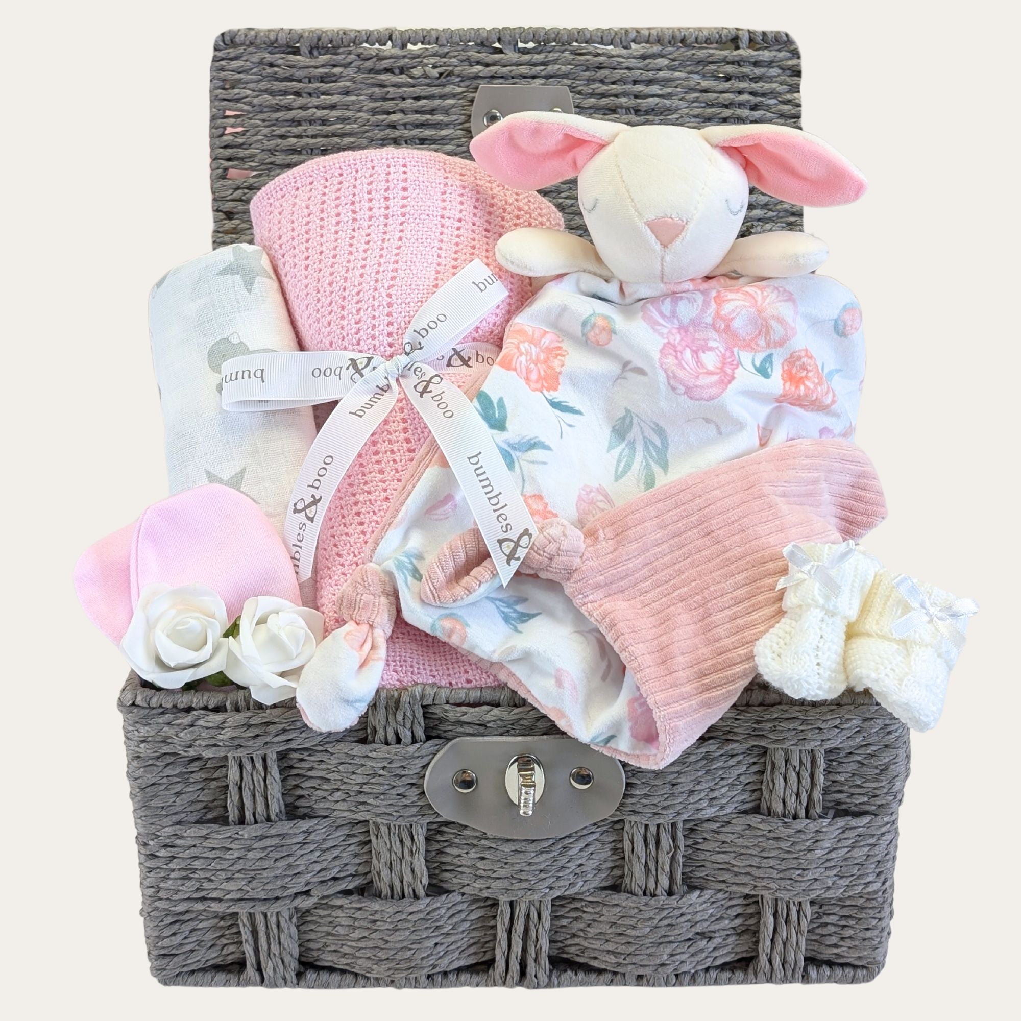 Baby girl gifts hamper basket with bunny comforter and pink cellular blanket.