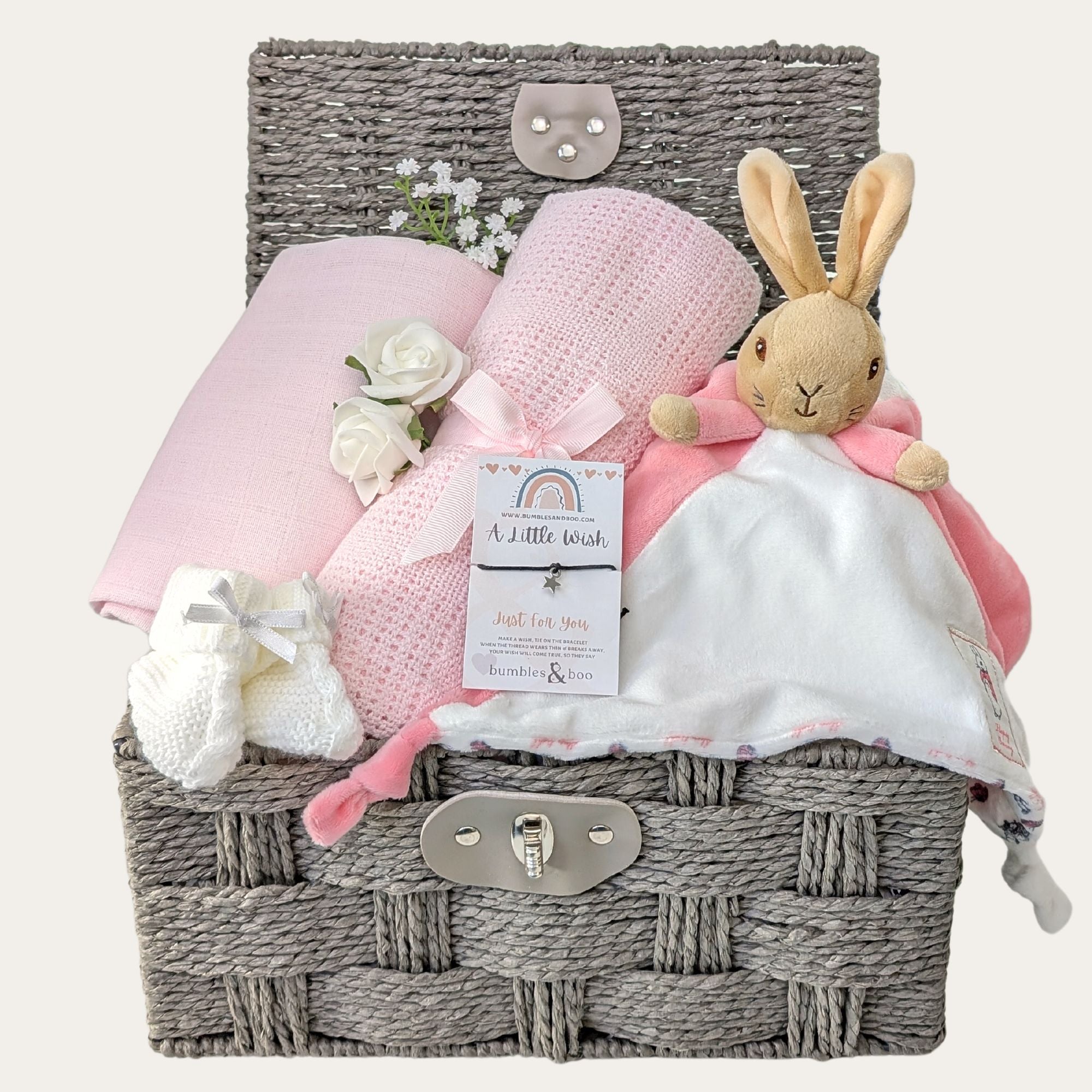 Baby girl gifts hamper basket with bunny comforter and pink cellular blanket.