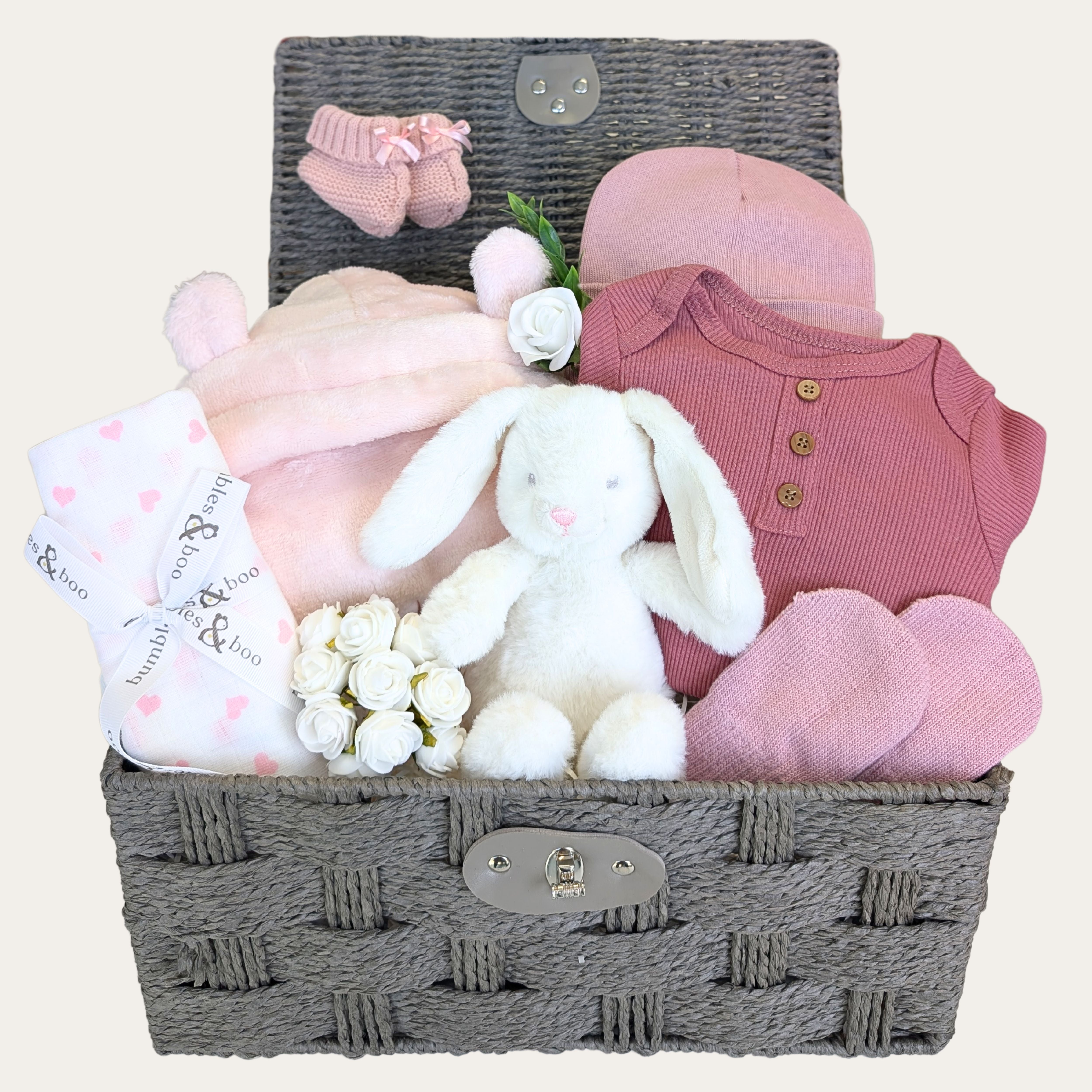 Baby girl gift basket with hooded dressing gown, baby vest, hat and mittens, soft toy and baby knit booties.