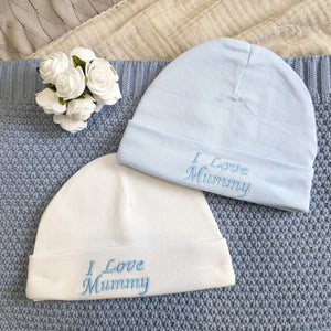 Baby hats blue and white, with 'I love mummy' wording on the brim.