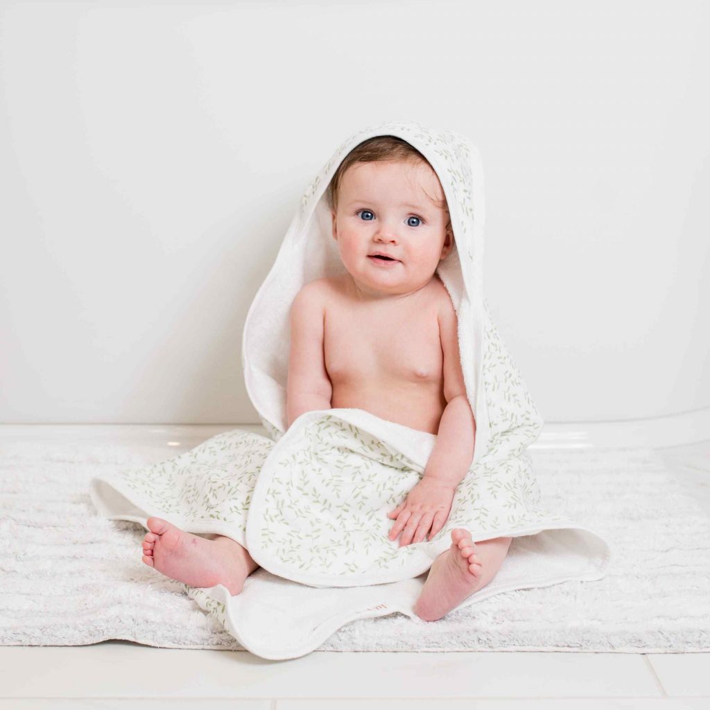 Soft white hooded bath towel with a green leaf print