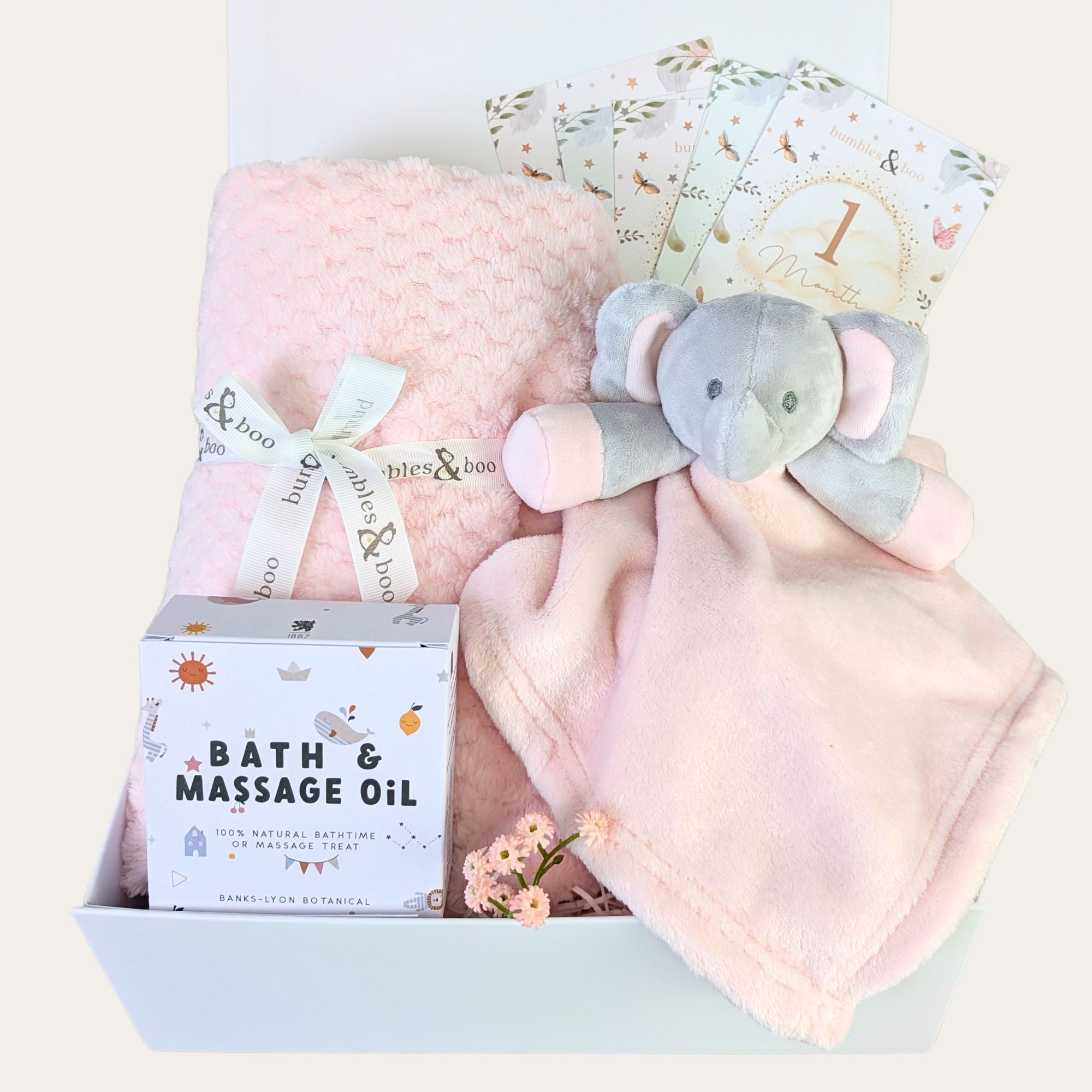 Baby shower gift box to include a pink baby blanket, soft pink elephant toy, massage baby oil and milestone cards. Bumbles and Boo.