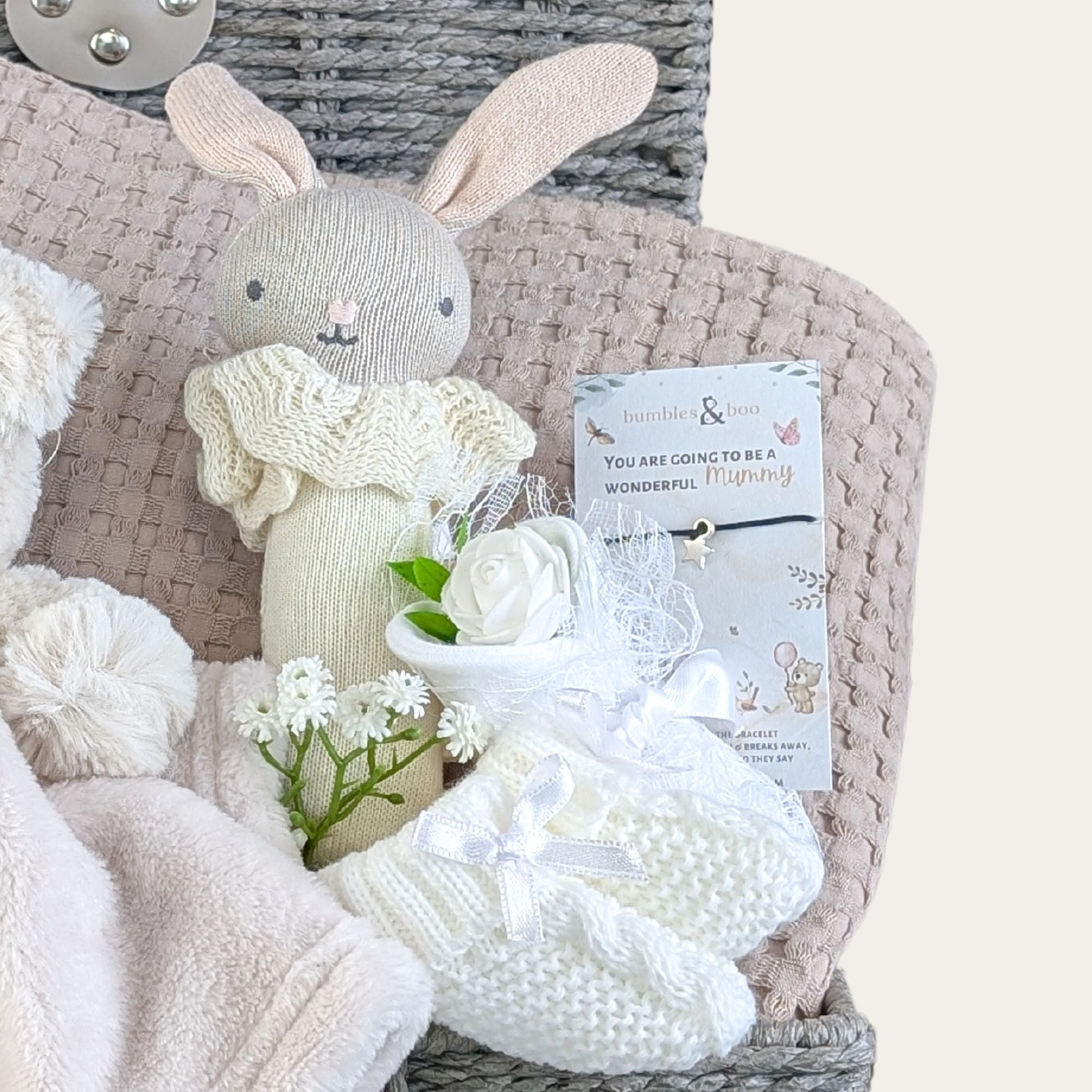 baby shower gifts basket with bunny baby rattle, bear comforter, organic blanket, baby booties and treat for mum.