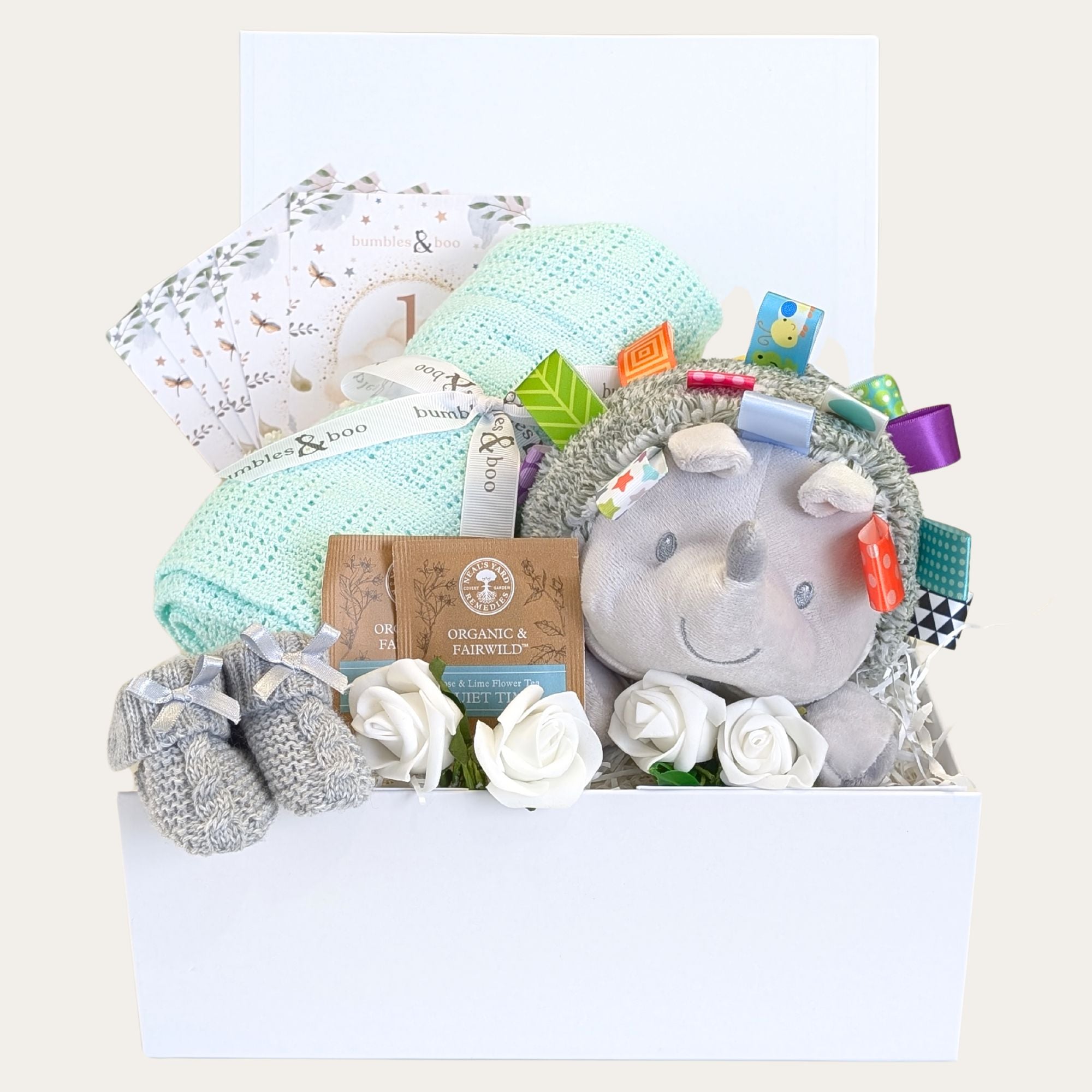 baby shower gifts box hamper with hedgehog taggie toy and mint cellular blanket all in a white lidded gift box.