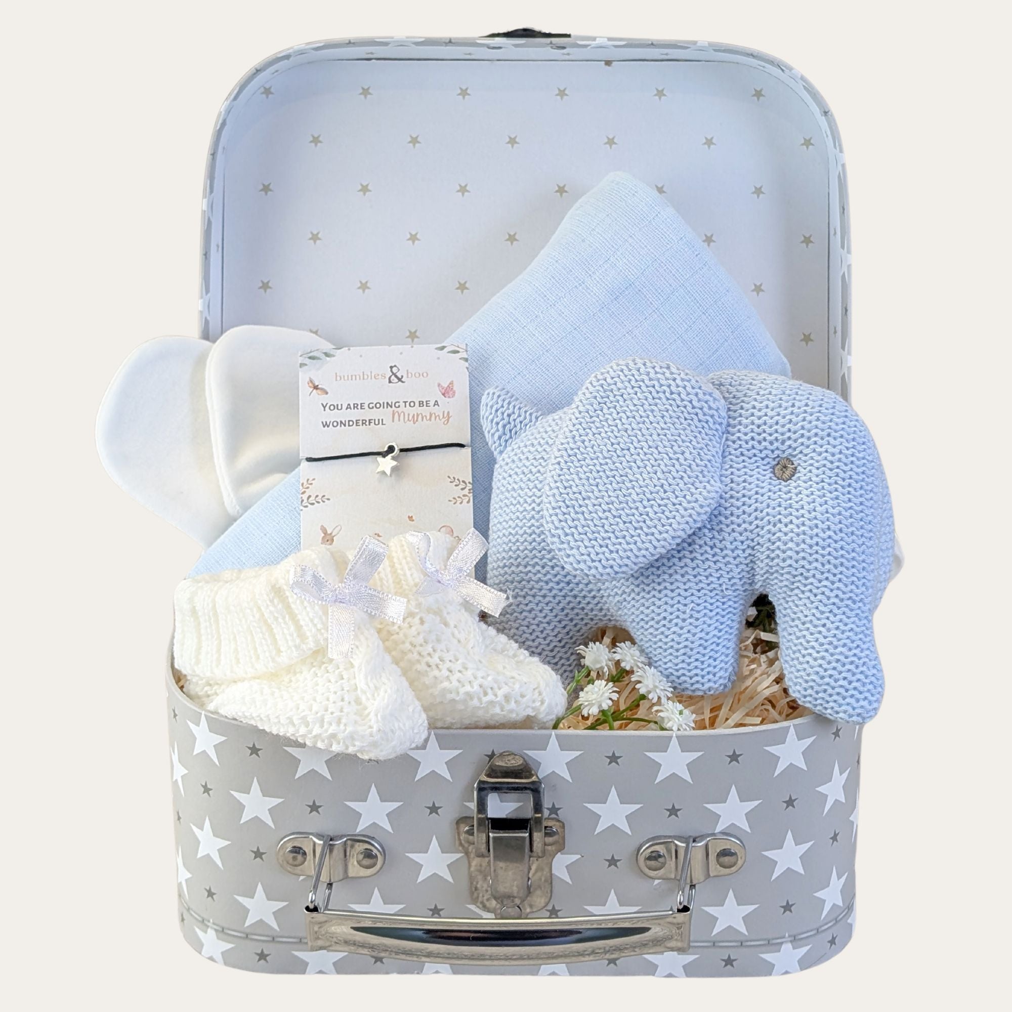 Baby shower gifts for boy with presents including pale blue elephant rattle in a stars hamper trunk.