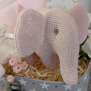 Close up of pink knit elephant baby rattle.