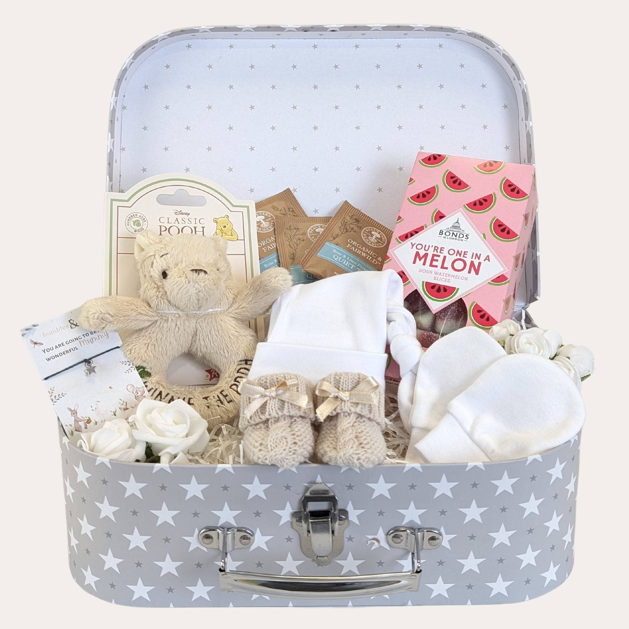 Baby shower gifts hamper with Winnie the Pooh rattle and presents for mum and baby.