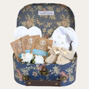 Baby shower gifts hamper with presents for mum and baby in a luxury floral luggage hamper.