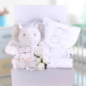 Baby shower hamper gifts in a white box with white elephant themed baby clothing set and soft toy.