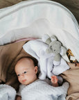 baby with a soft elephant comforter toy in white and grey