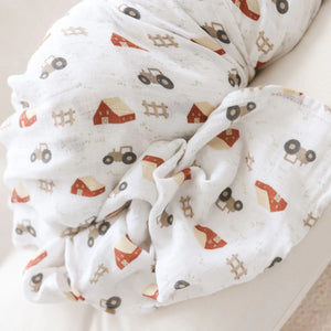 Two cotton muslin baby swaddles with barnyard designs,