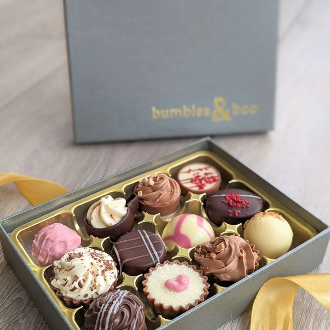 Twelve luxury chocolates in a  box.