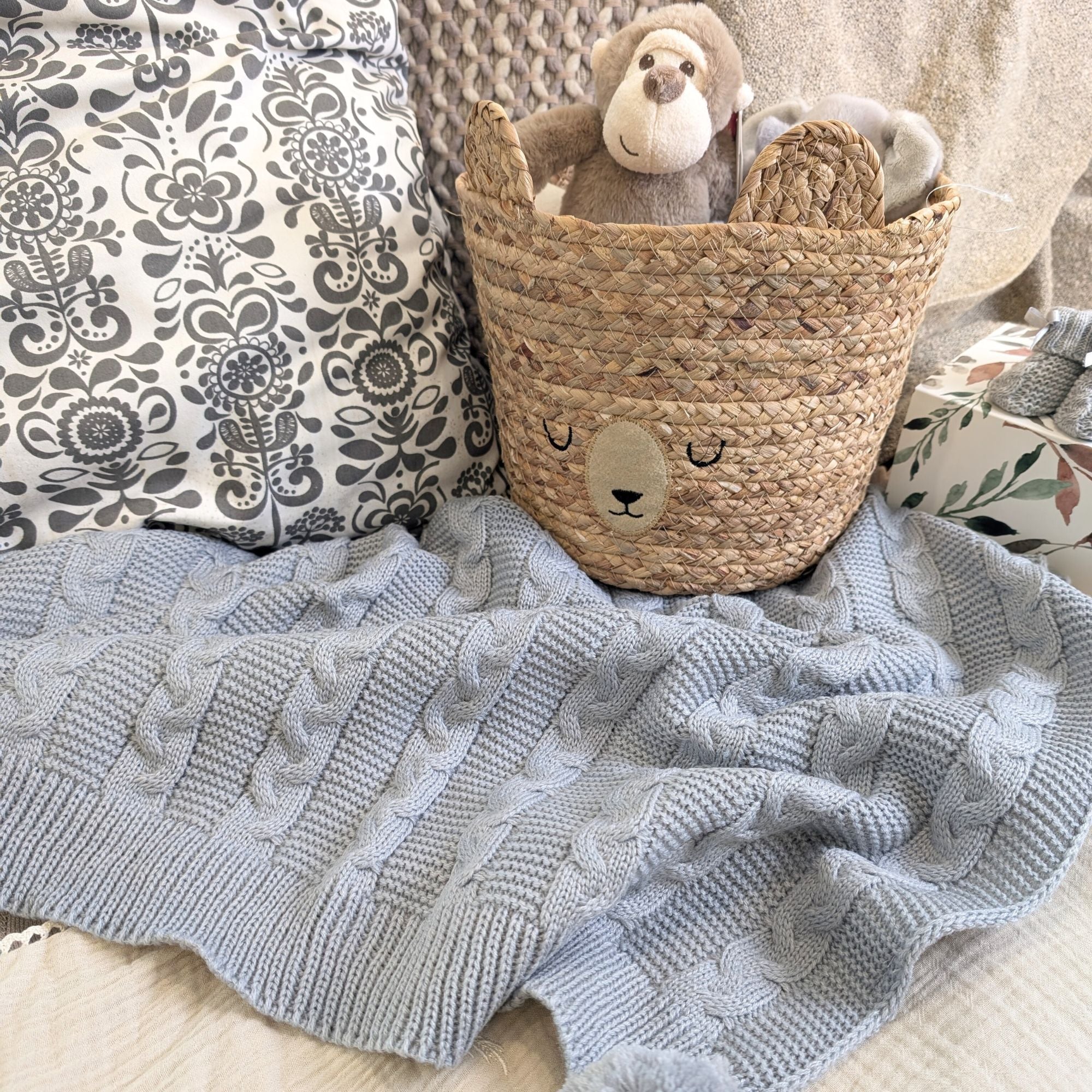 Grey cable knit baby blanket – soft recycled wrap with pom poms. Bumbles and Boo.