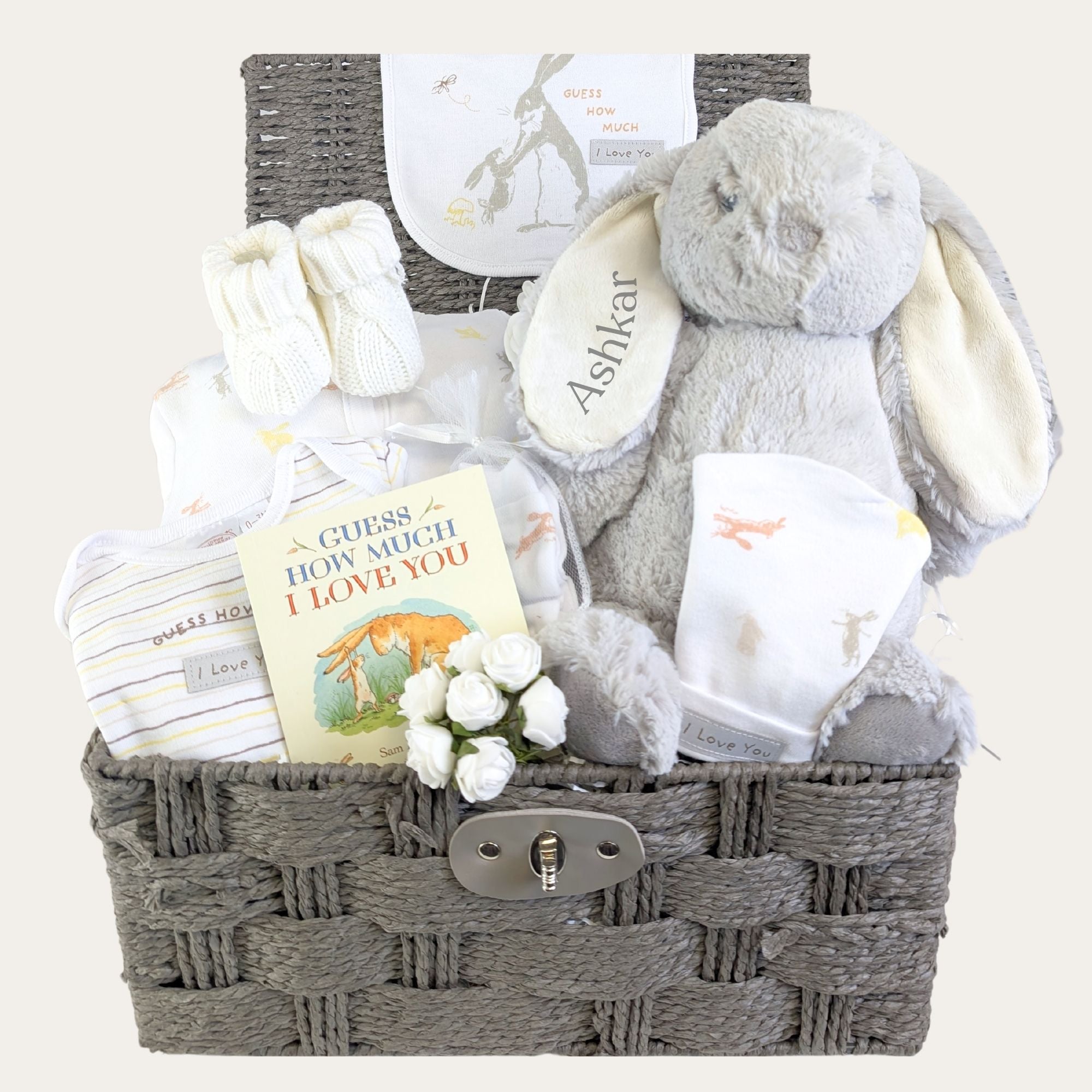 personalised new baby gifts basket with a bunny rabbit soft toy and bunny themed sleepsuit in soft cotton. 