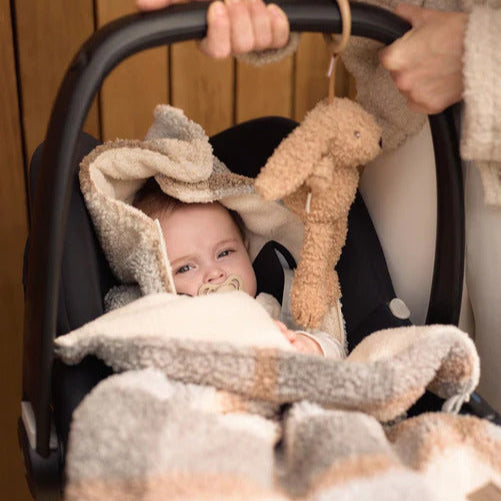 Car Seat Hanging Bunny Toy in Riverside bouclé fabric with crinkly ears, labels, and strings for baby sensory play.