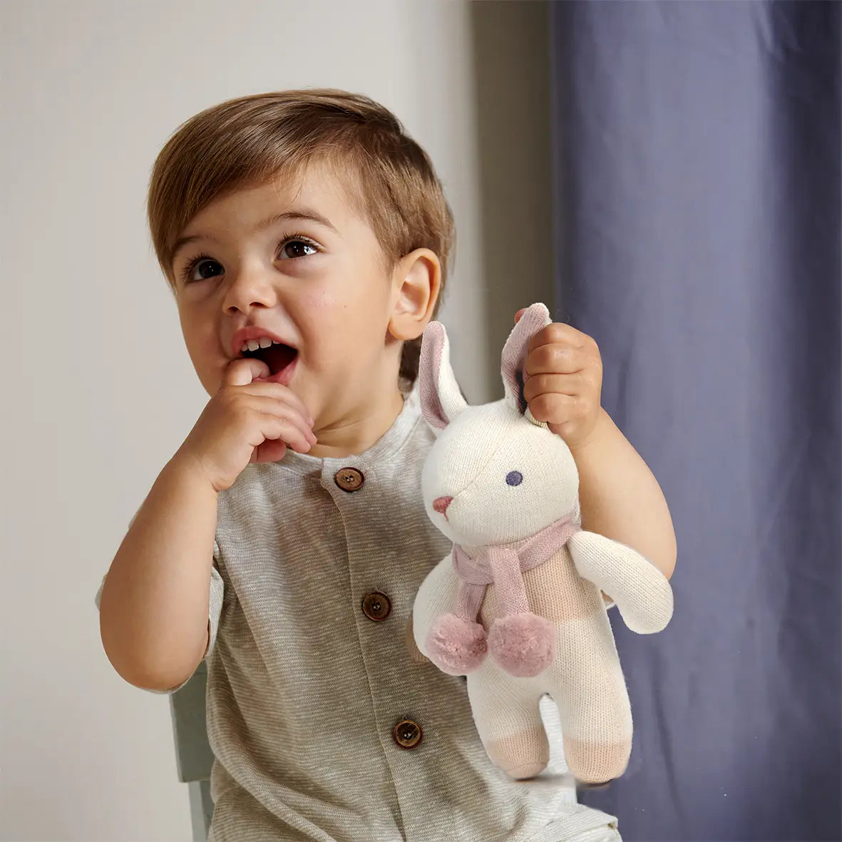 white soft toy bunny rabbit rattle with a scarf and dungarees