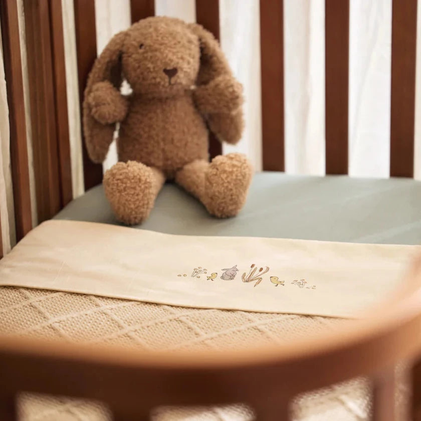 knitted neutral oatmeal coloured baby blanket with a check pattern