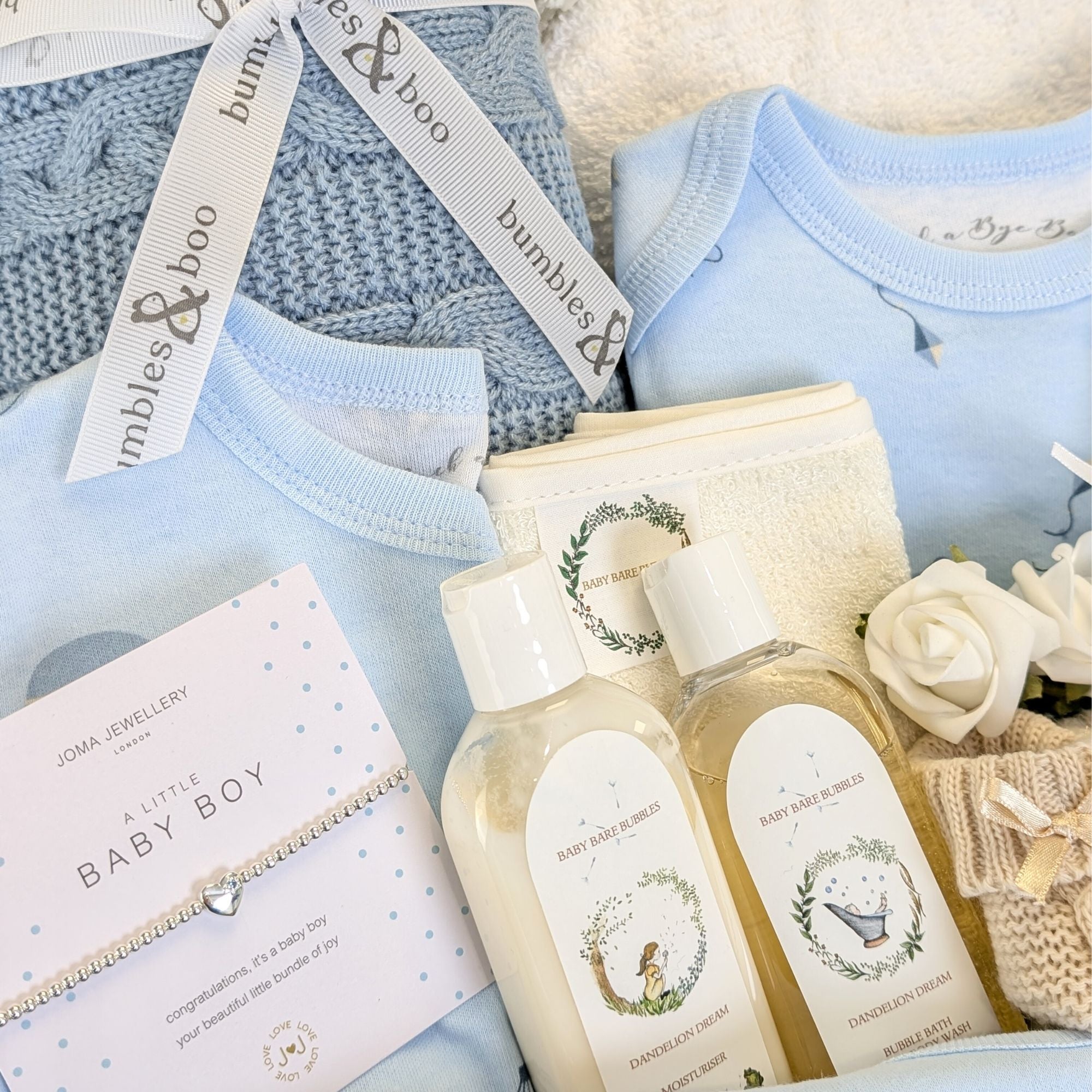 close up of a baby boy gifts hamper with baby wash, blanket and baby clothing