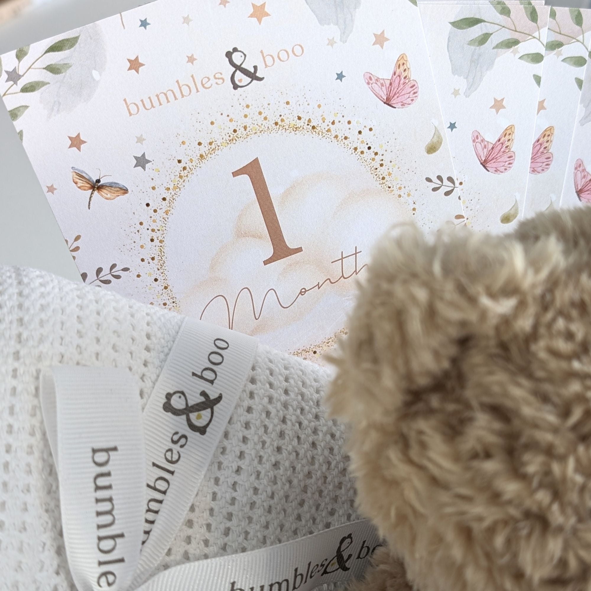 close up of baby milestone cards in a new baby gifts hamper