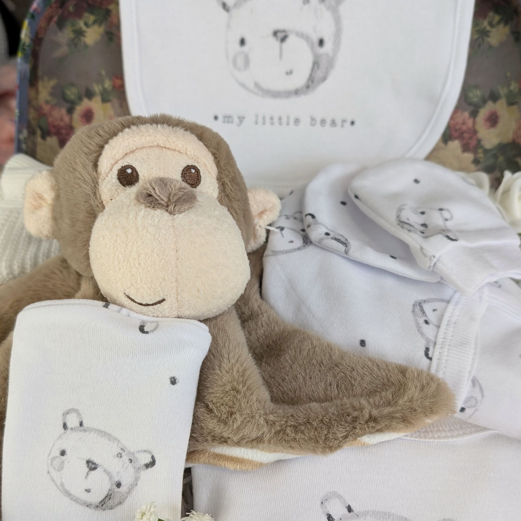 close up of a monkey comforter and bear clothing set