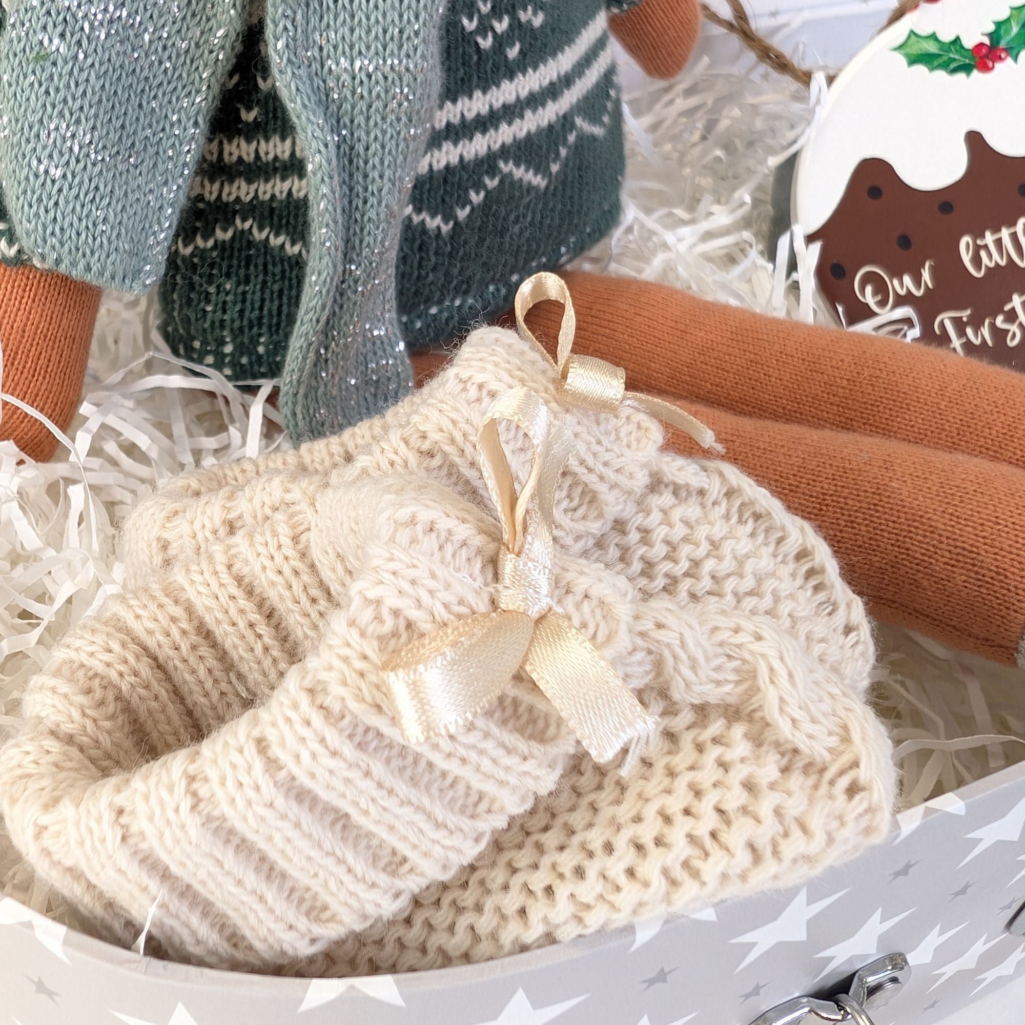 close up christmas hamper with beige knit booties