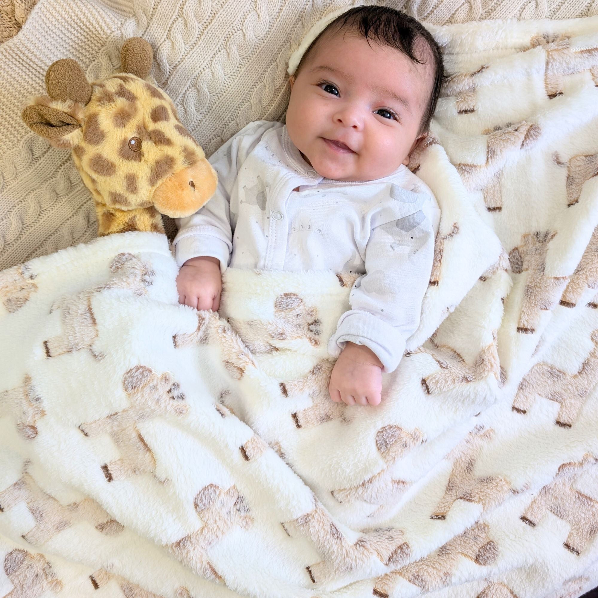 soft cream baby blanket with giraffes on. 