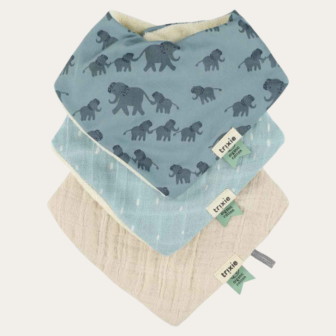 All three Organic Bandana Bibs displayed, showcasing the elephant print and two solid muslin bibs