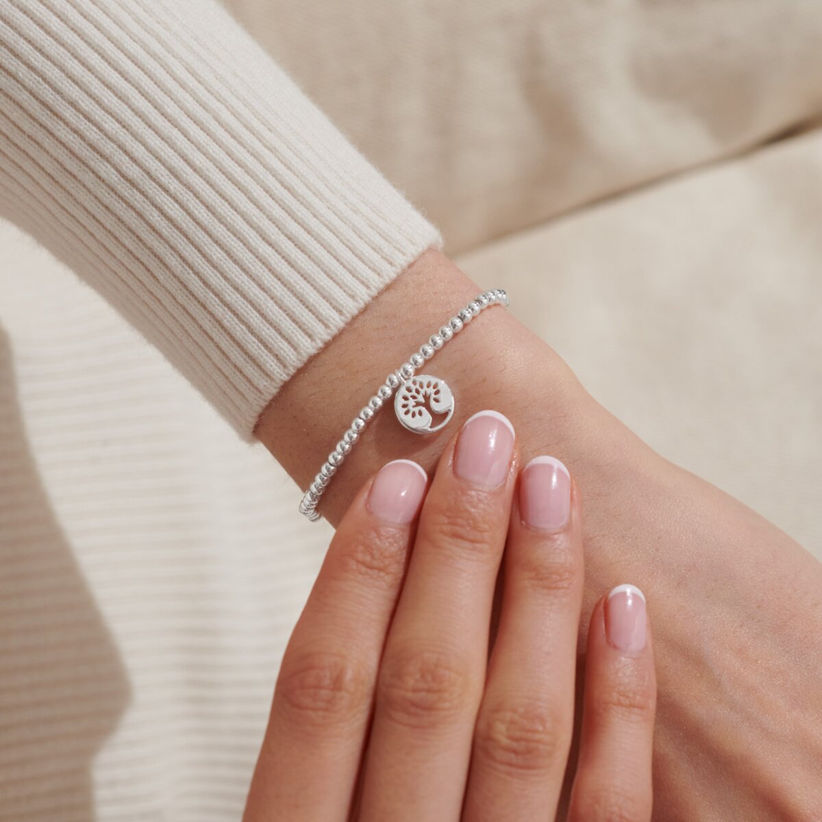 silver beaded bracelet with a family tree charm 