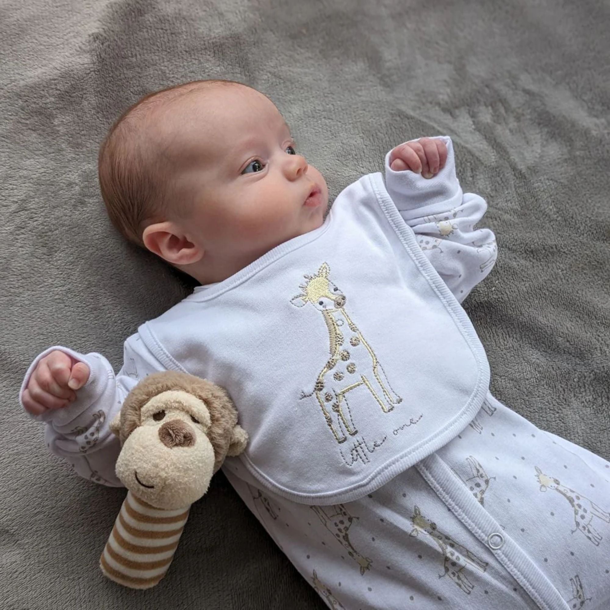 giraffe cotton baby clothing set on a newborn baby