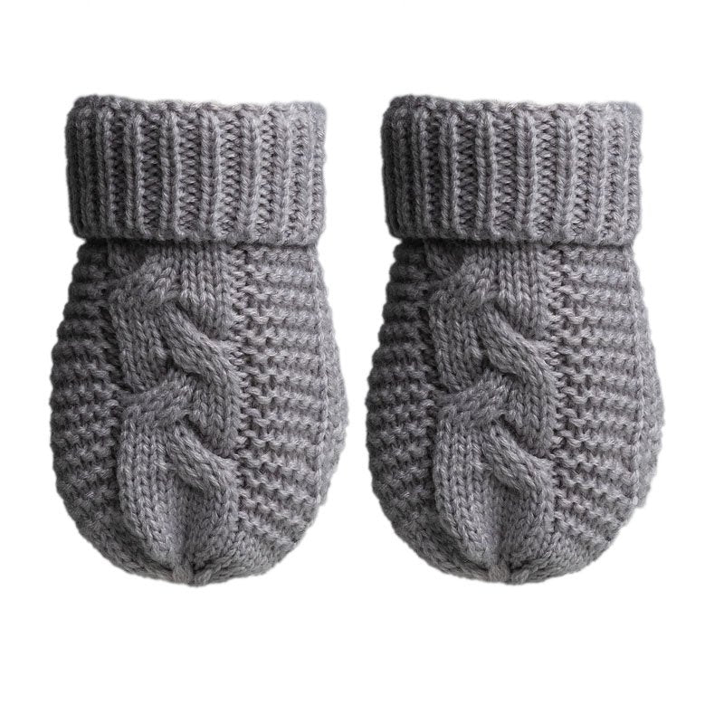 A pair of cable knit soft grey mittens