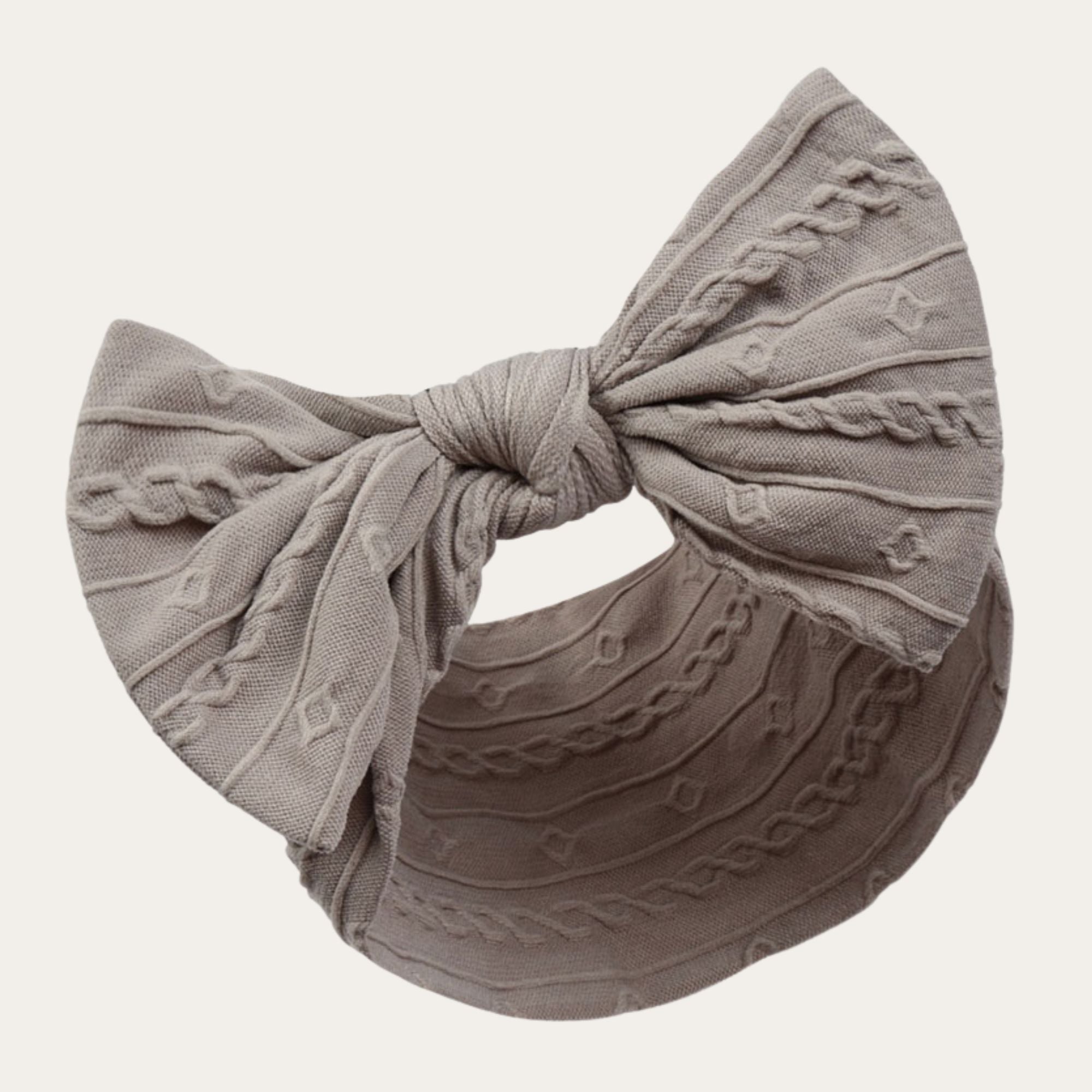 Adorable soft grey baby headband with cable knit pattern design and striking bow. Perfect for photoshoots. 