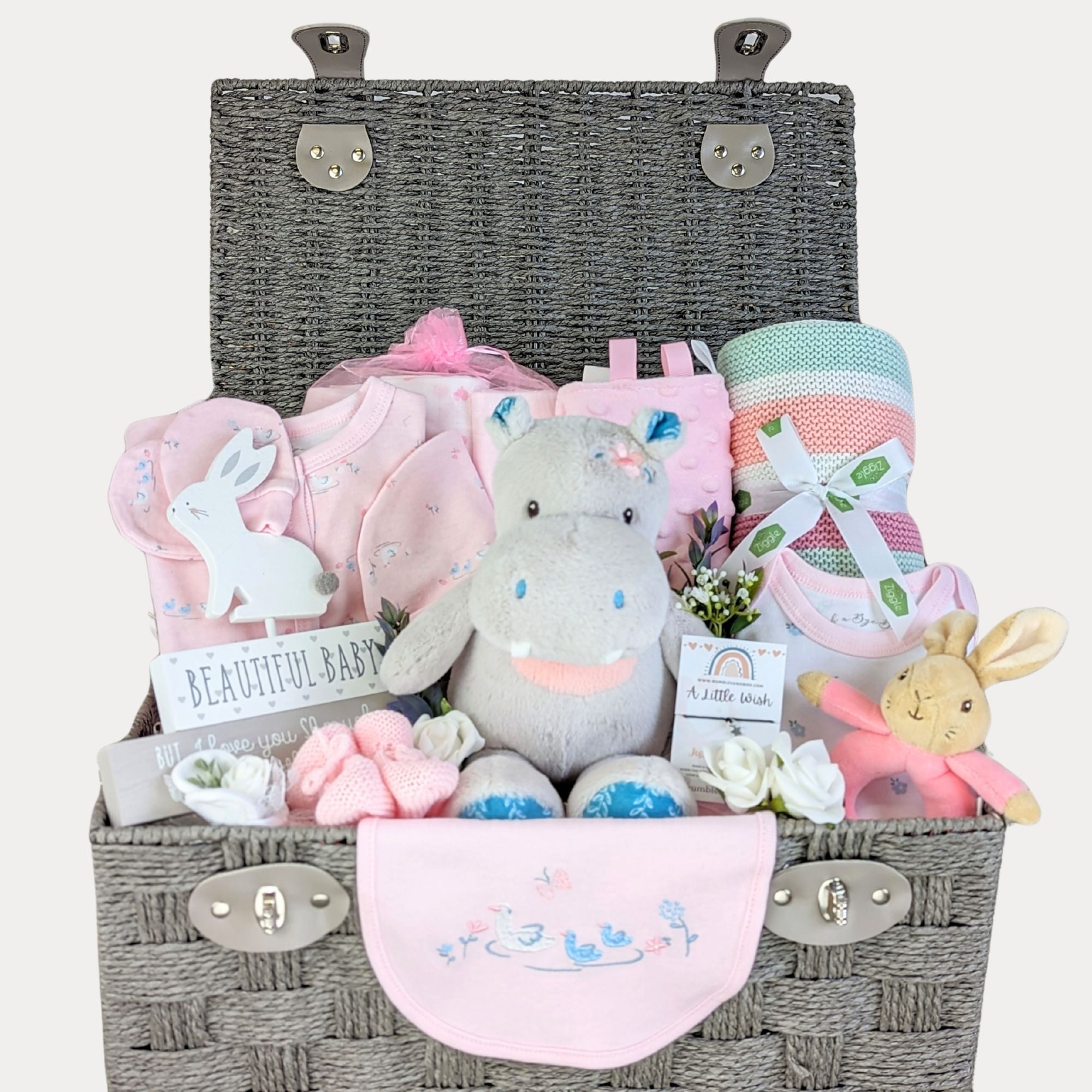 large baby girl gifts hamper basket with hippo soft toy, stripy blanket and pink baby clothes set. 