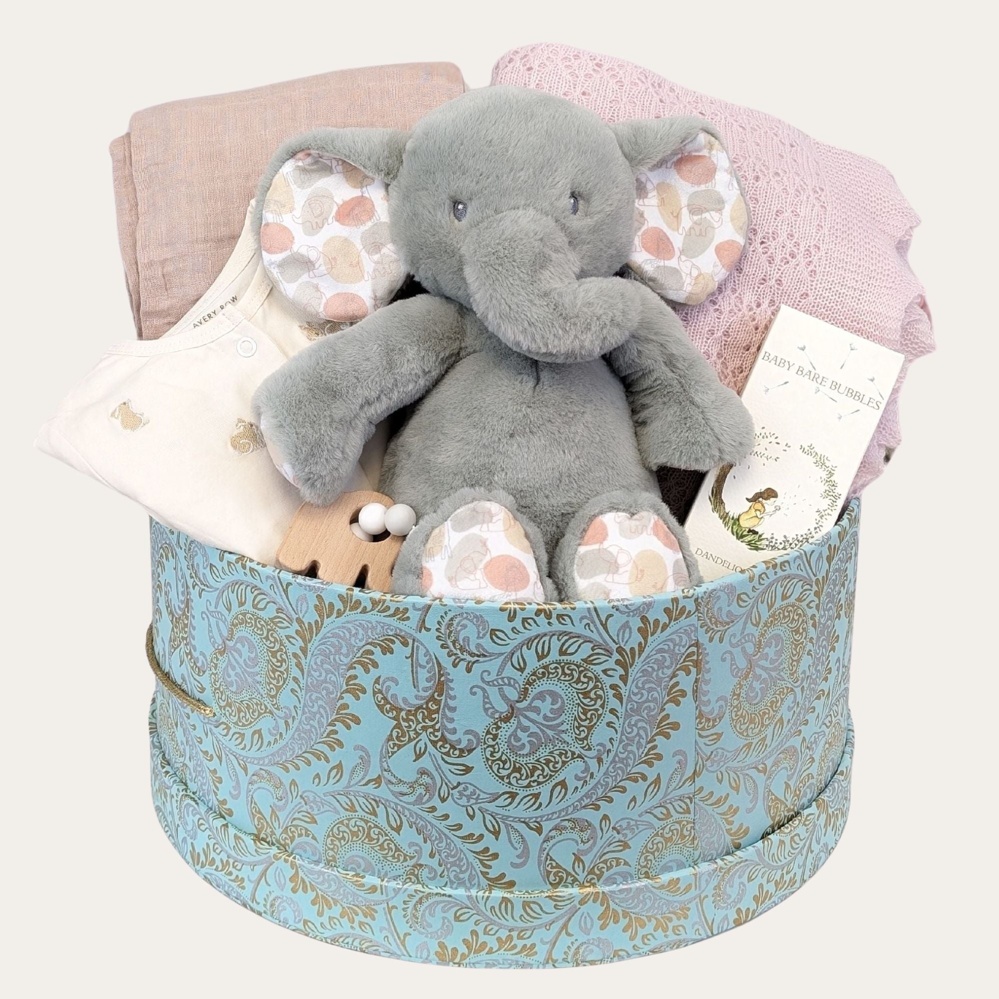 large baby girl gifts box with cashmere blanket in pink, organic cotton muslin, elephant soft toy, clothing, in a circular hamper with lid.