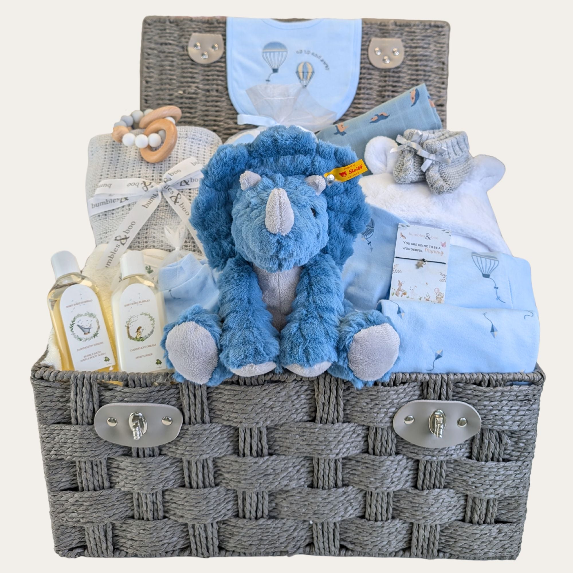 Large baby boy hamper basket with gifts including Steiff dinosaur soft toy, baby clothes set, personalised dressing gown.