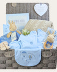 Large peter rabbit baby boy gifts hamper with beige blanket, journal and clothing.