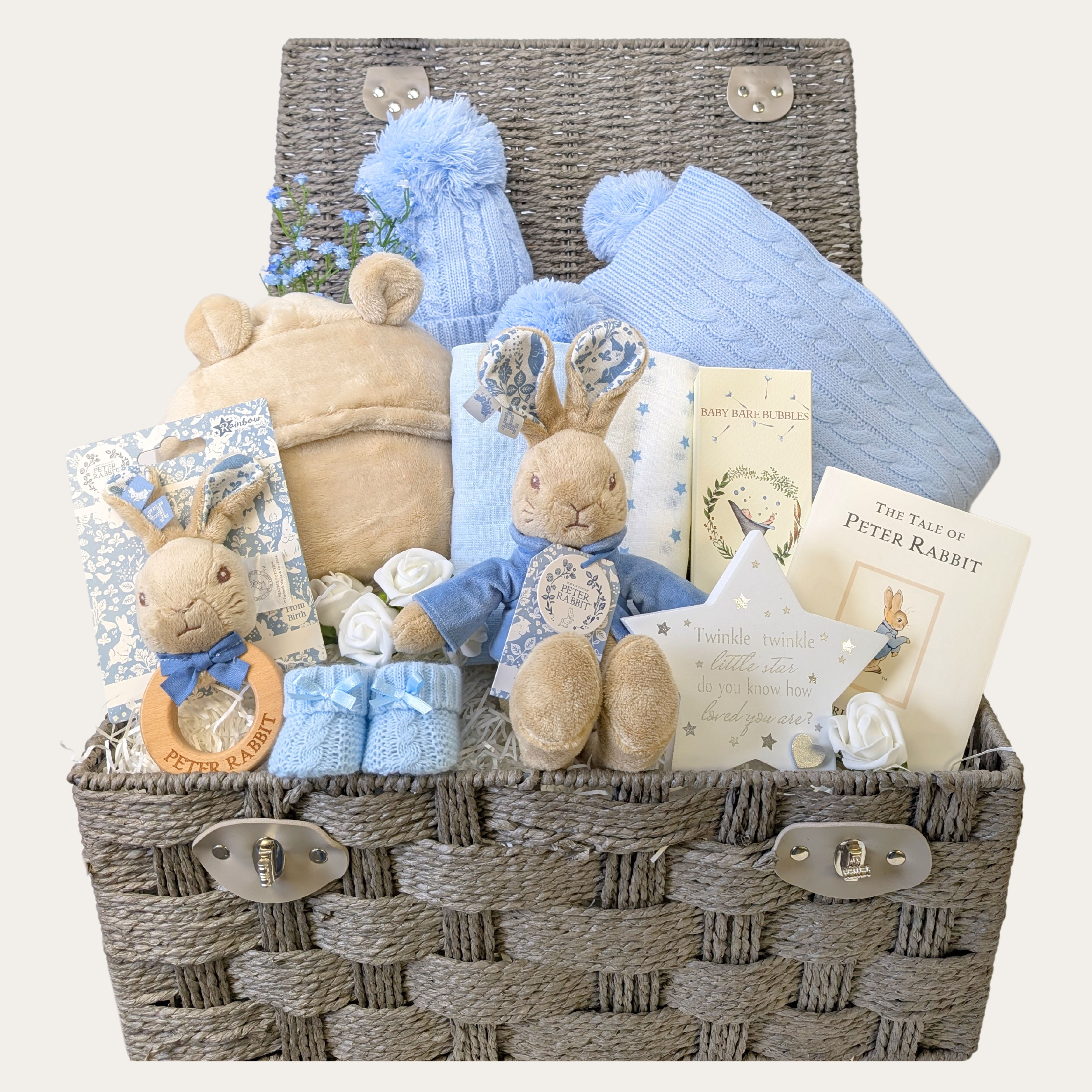 Large peter rabbit baby boy gifts hamper with beige blanket, journal and clothing.