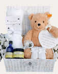 New baby gifts hamper basket with steiff teddy bear, blanket, skincare and bracelet for mum.