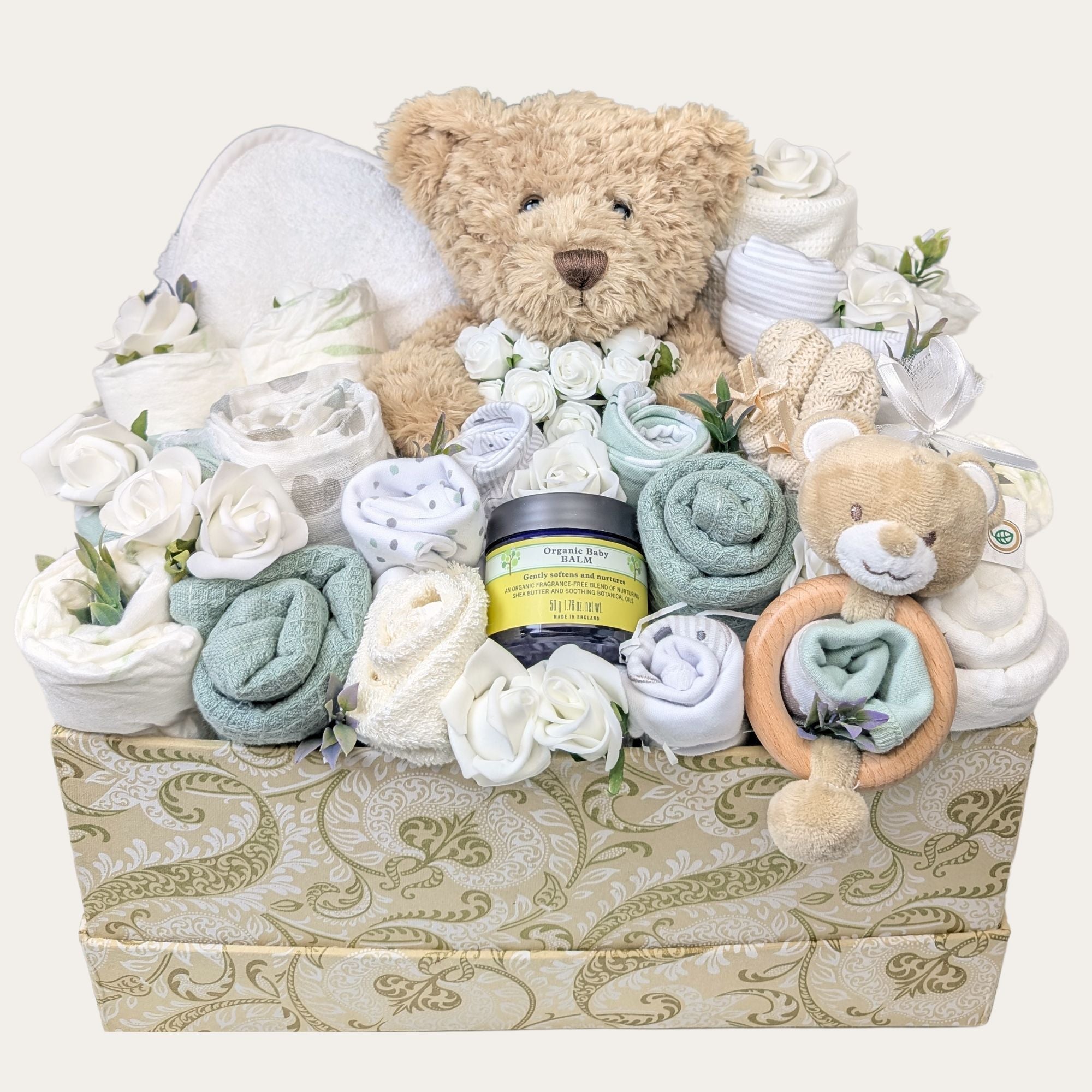 baby hamper with teddy bear, rattle, towel, blanket, baby booties, organic baby balm, flannels and muslin squares.