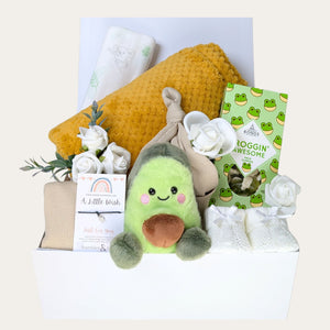 pregnancy gift hamper with mustard yellow baby blanket, muslin, bib, hat, sweets, booties and avocado soft toy.