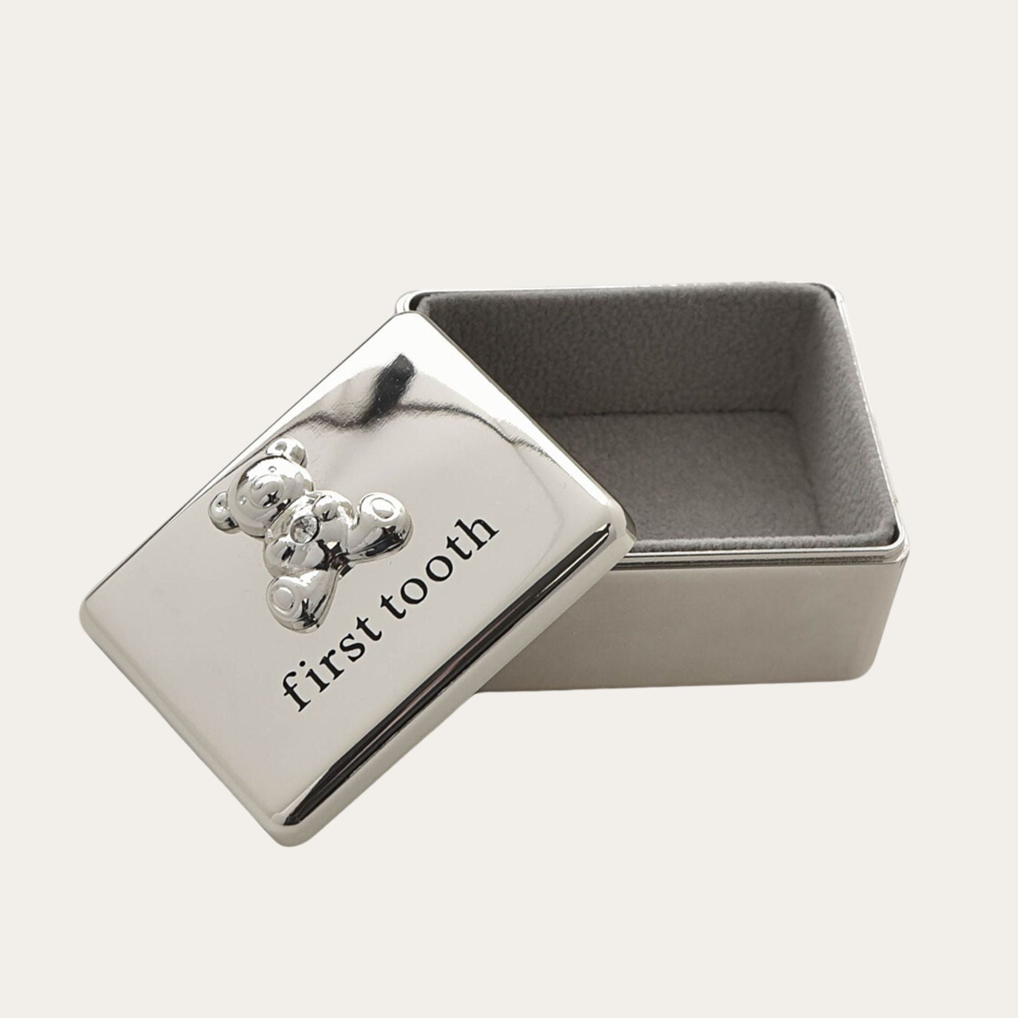 Silver first tooth box with teddy embossed on the lid.