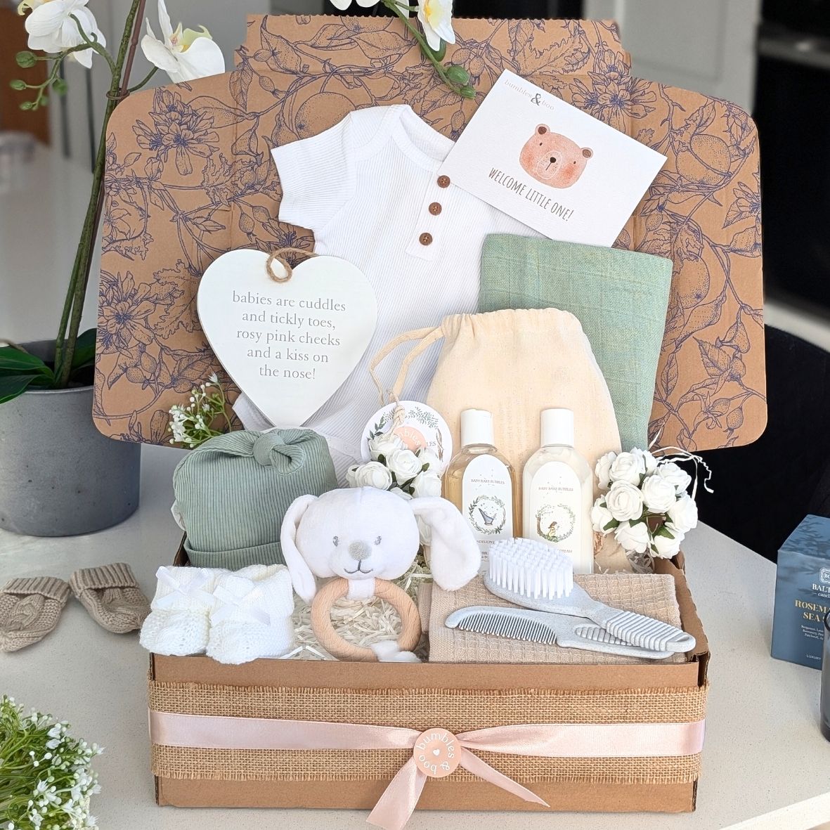 neutral baby gift box with vest, muslin, hat, skincare, booties and brush and comb. bumbles and boo