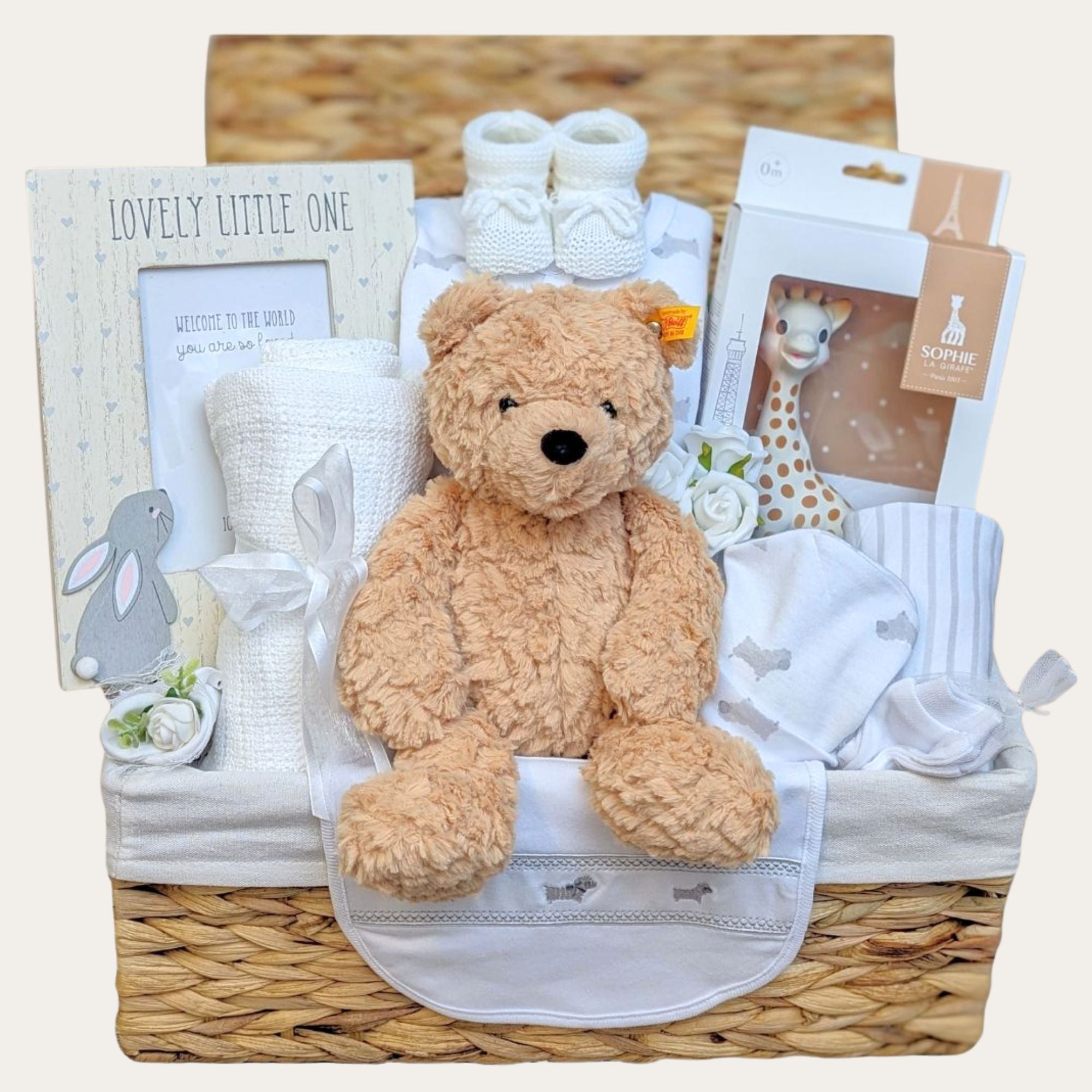 New baby gifts hamper basket with Steiff teddy bear, Sophie La Girafe teething toy, baby blanket and baby clothing set.