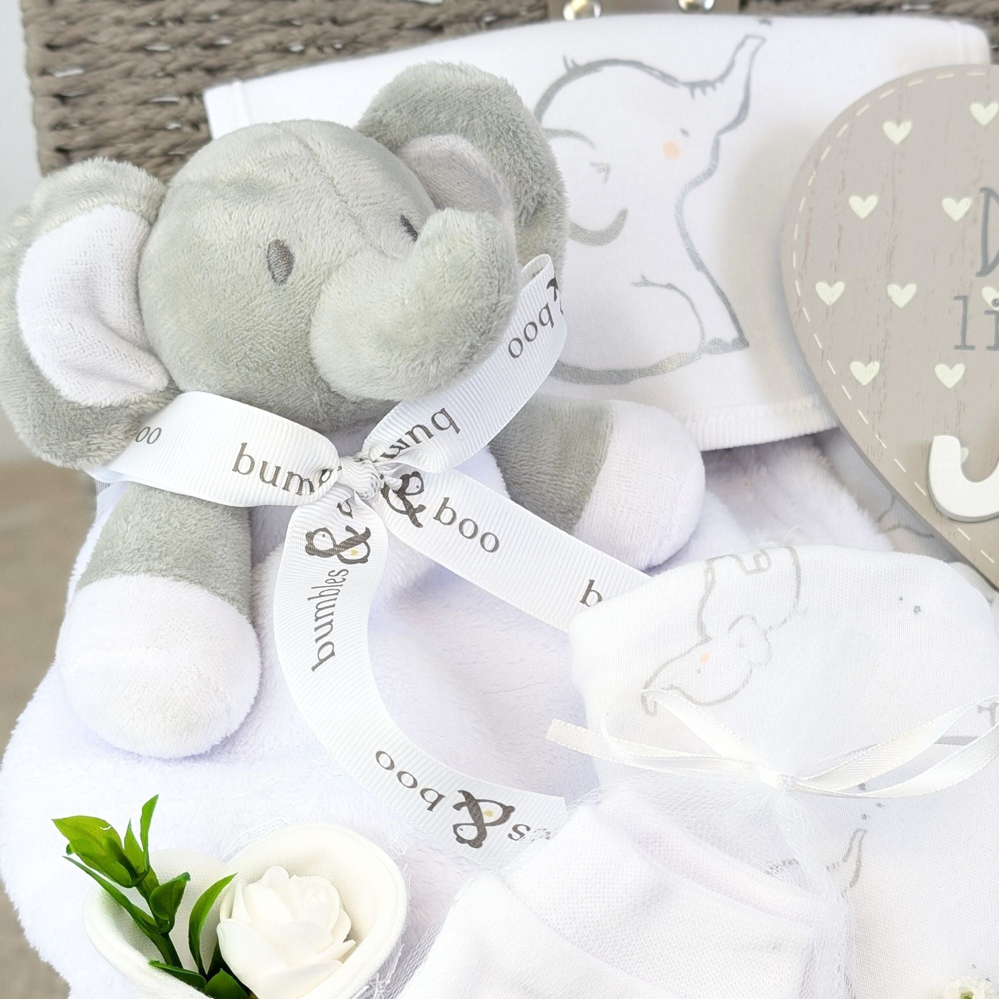 new baby gifts basket with white clothing set, elephant soft toy, baby plaque and baby mittens.
