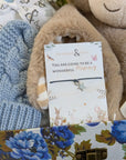 close up of a new mum wish string bracelet in a new baby boy hamper